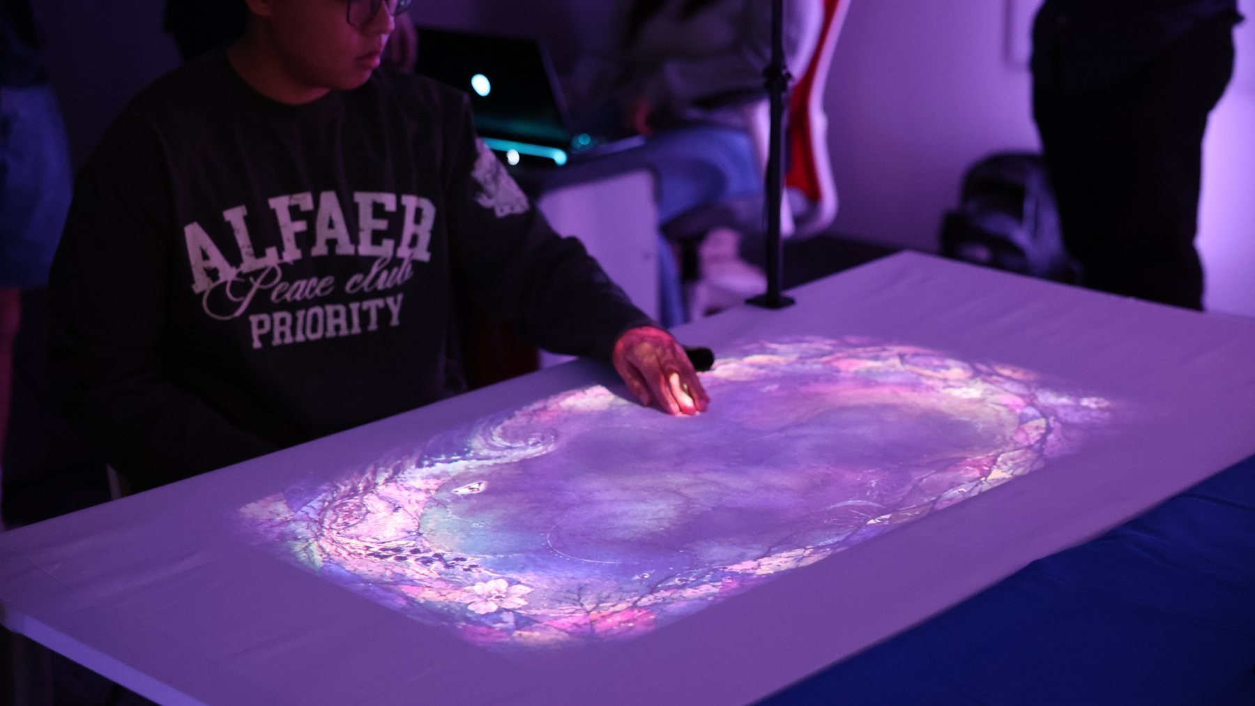 Audience member using the projected table during Project Projection